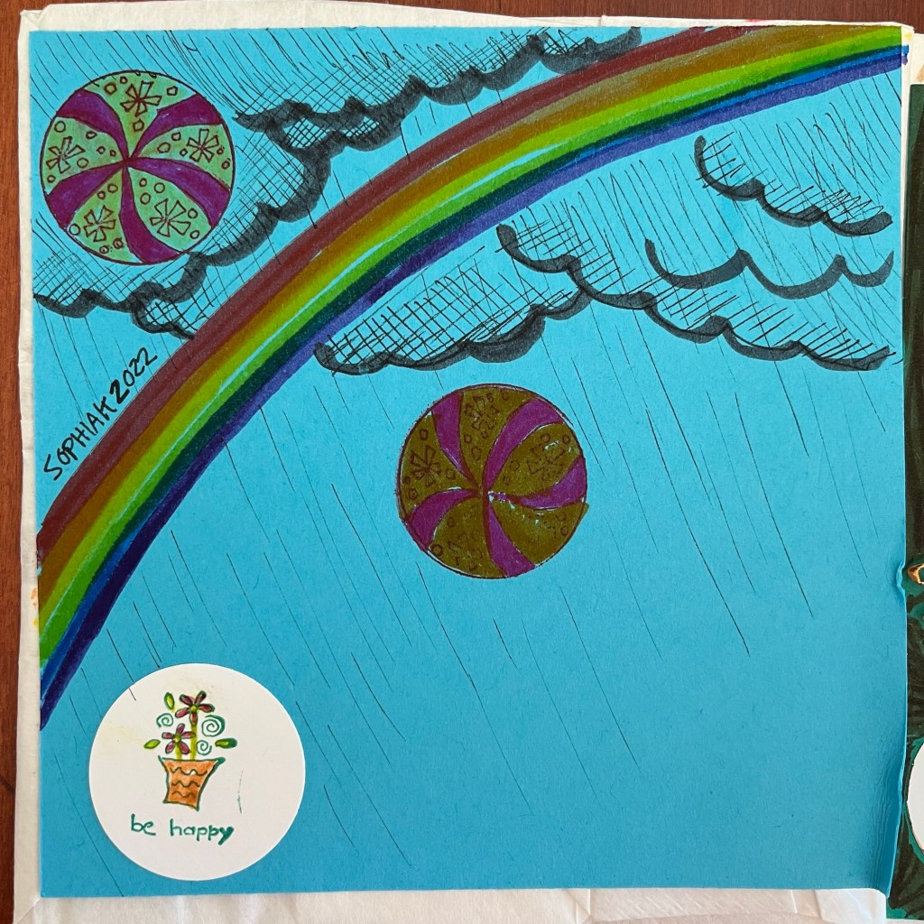 rainbow and two beach balls