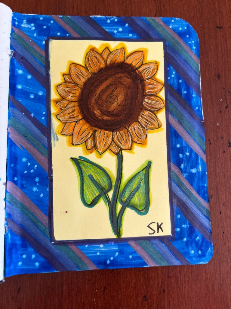 rainbow stripes surrounding a sunflower drawing