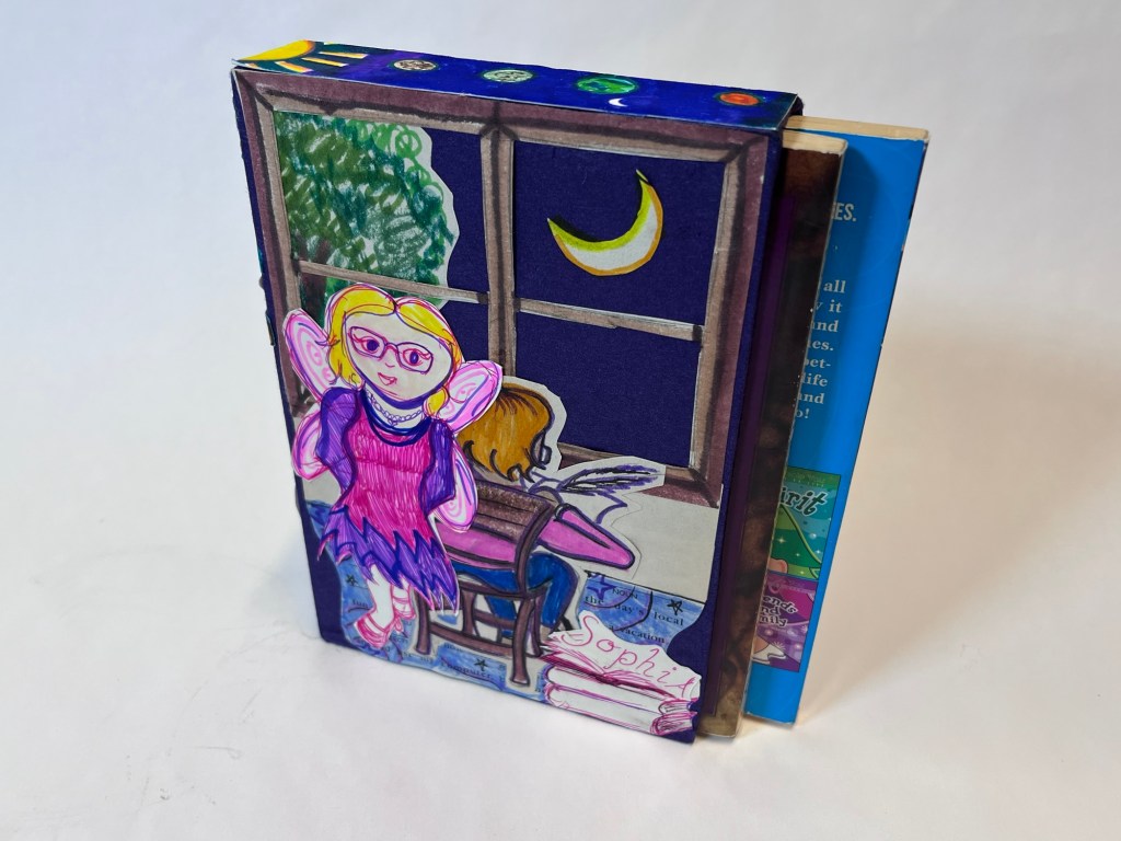 slipcase with a drawing of sophia at a writing desk, looking out a window, and a drawing of a fairy