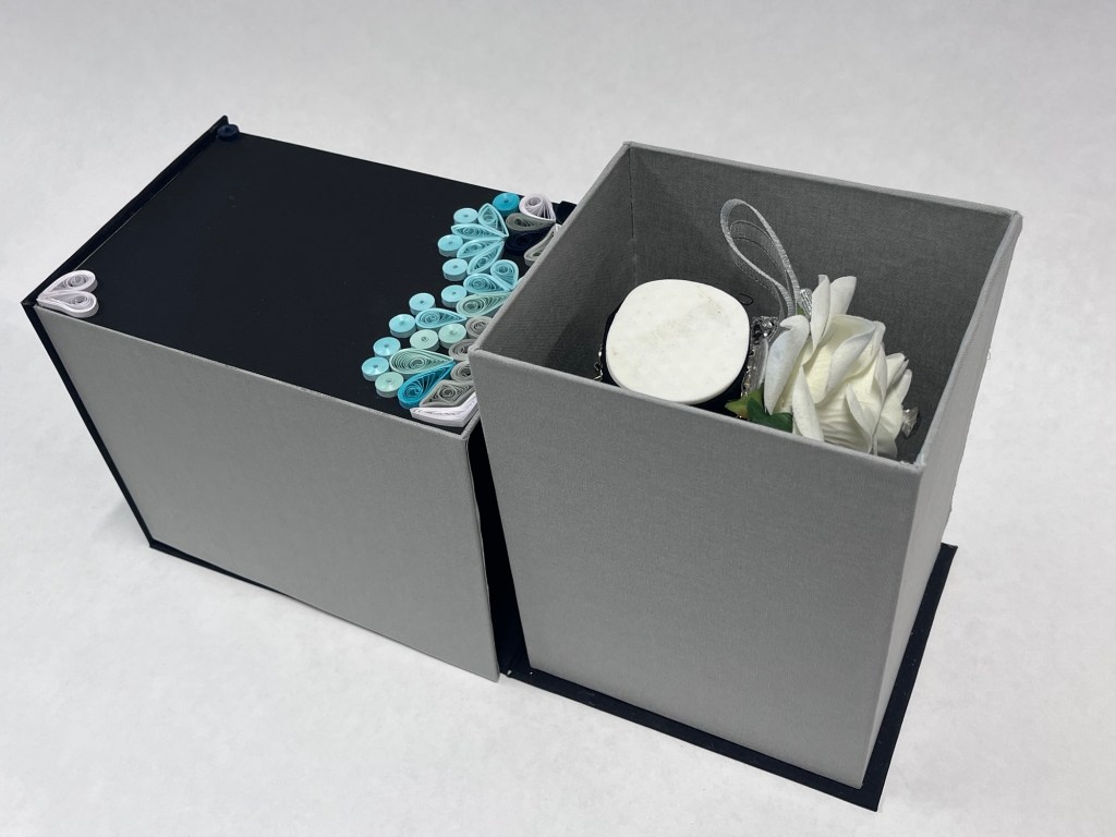 inside of the box there is a hand sculpture