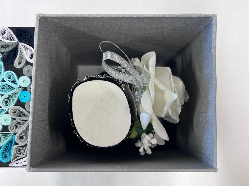 inside of the box is a decorated hand sculpture
