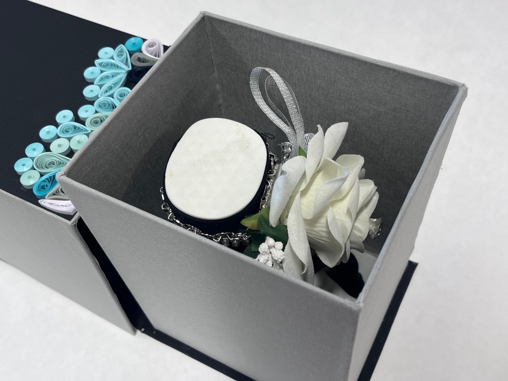 inside of a large box is a decorated hand sculpture