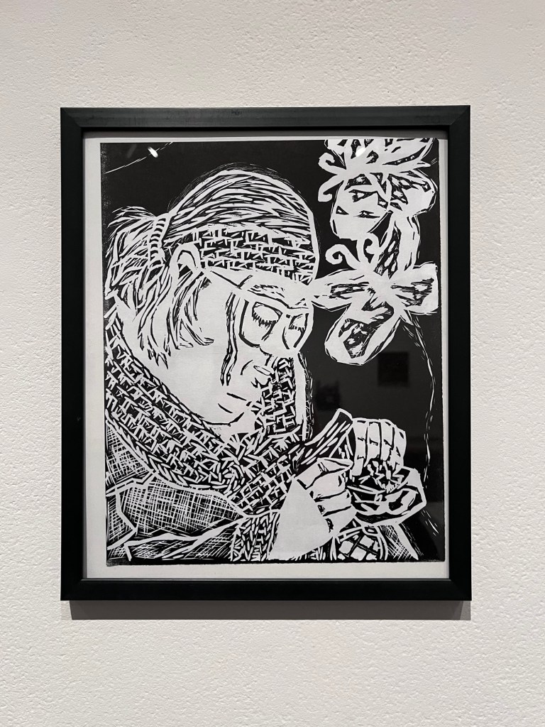 a black and white linocut print of sophia making a butterfly craft