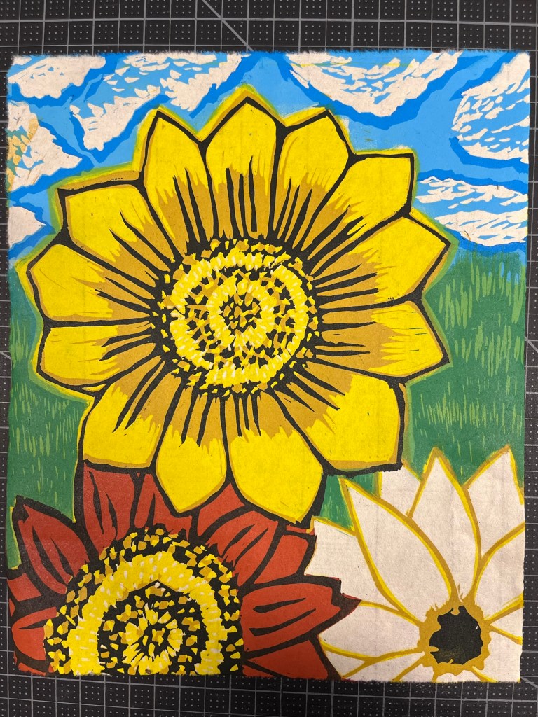 a linocut print of three sunflowers of various types