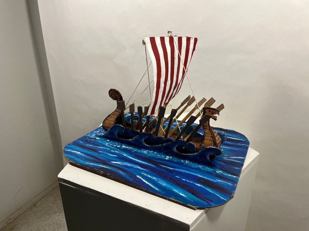 cardboard sculpture of a viking longship 
