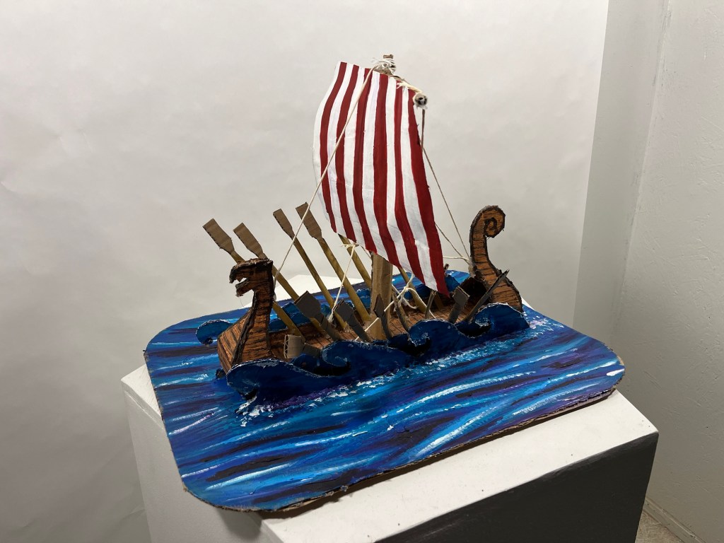 cardboard sculpture of a viking longship 