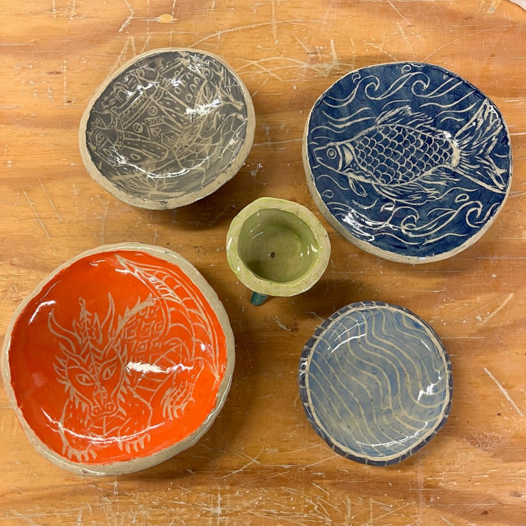 five colored plates and one empty planter