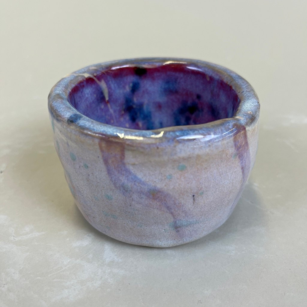purple cup with wavy stripes on the outside