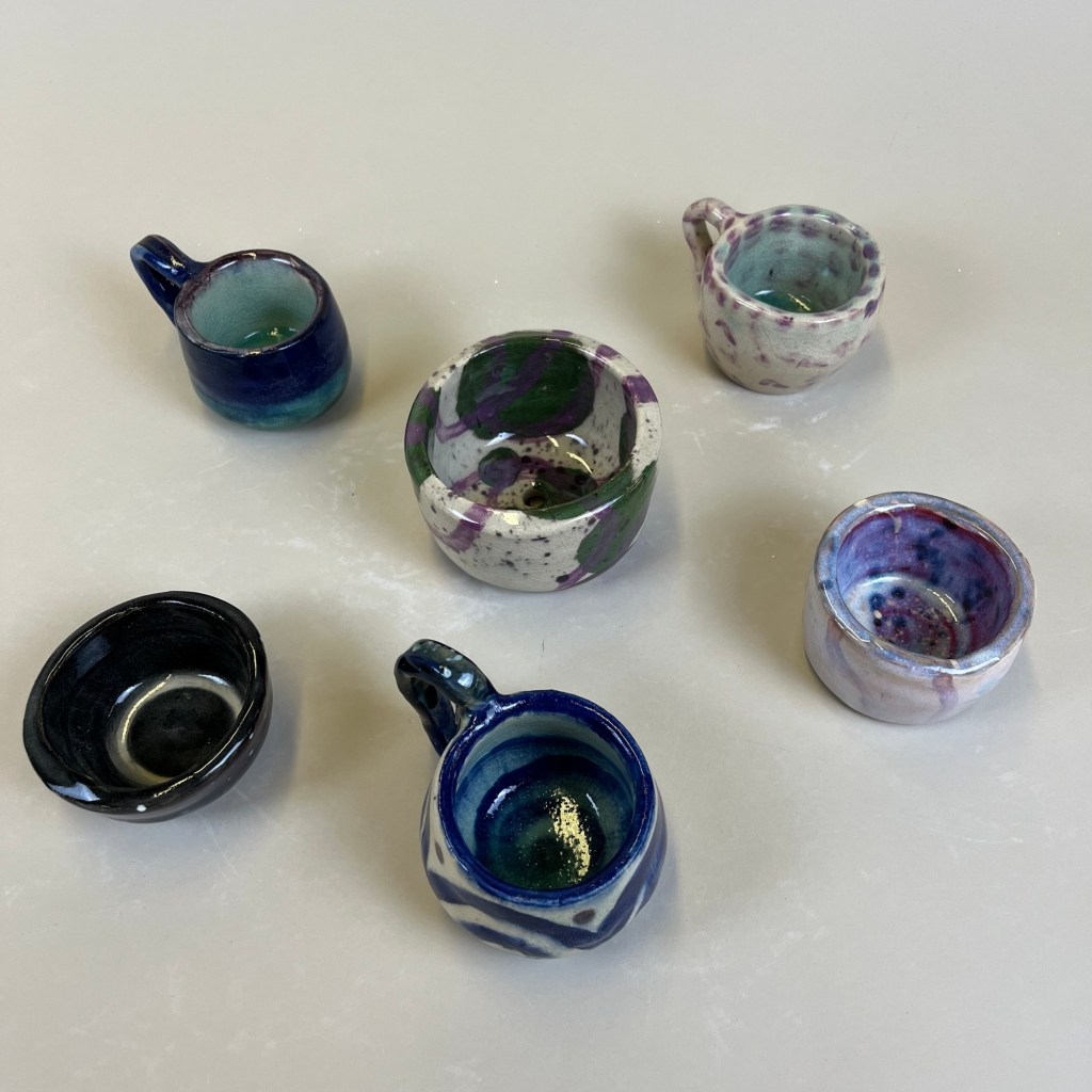 six ceramic mugs and bowls